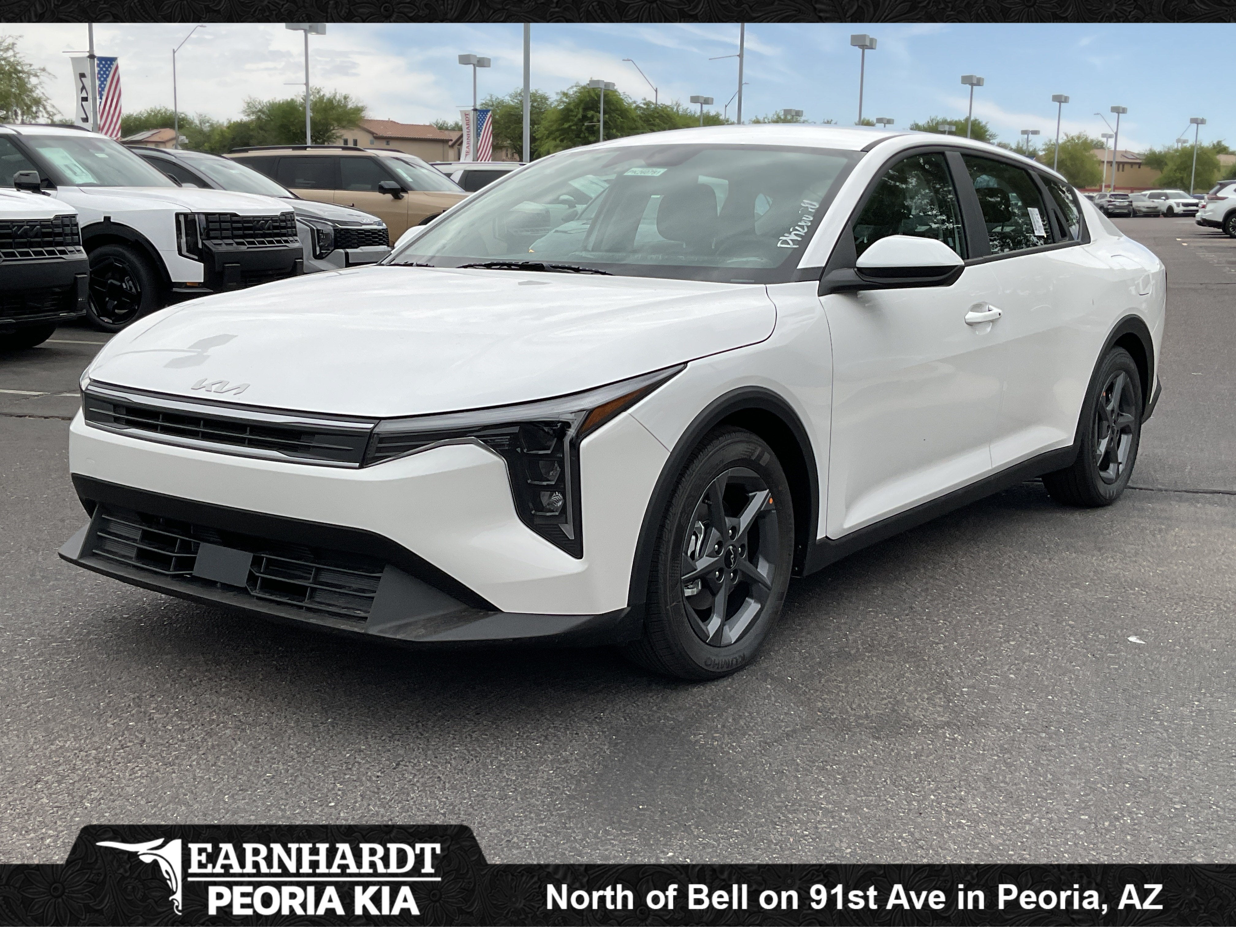 2026 Kia K4 LXS in Snow White Pearl — front three-quarter view