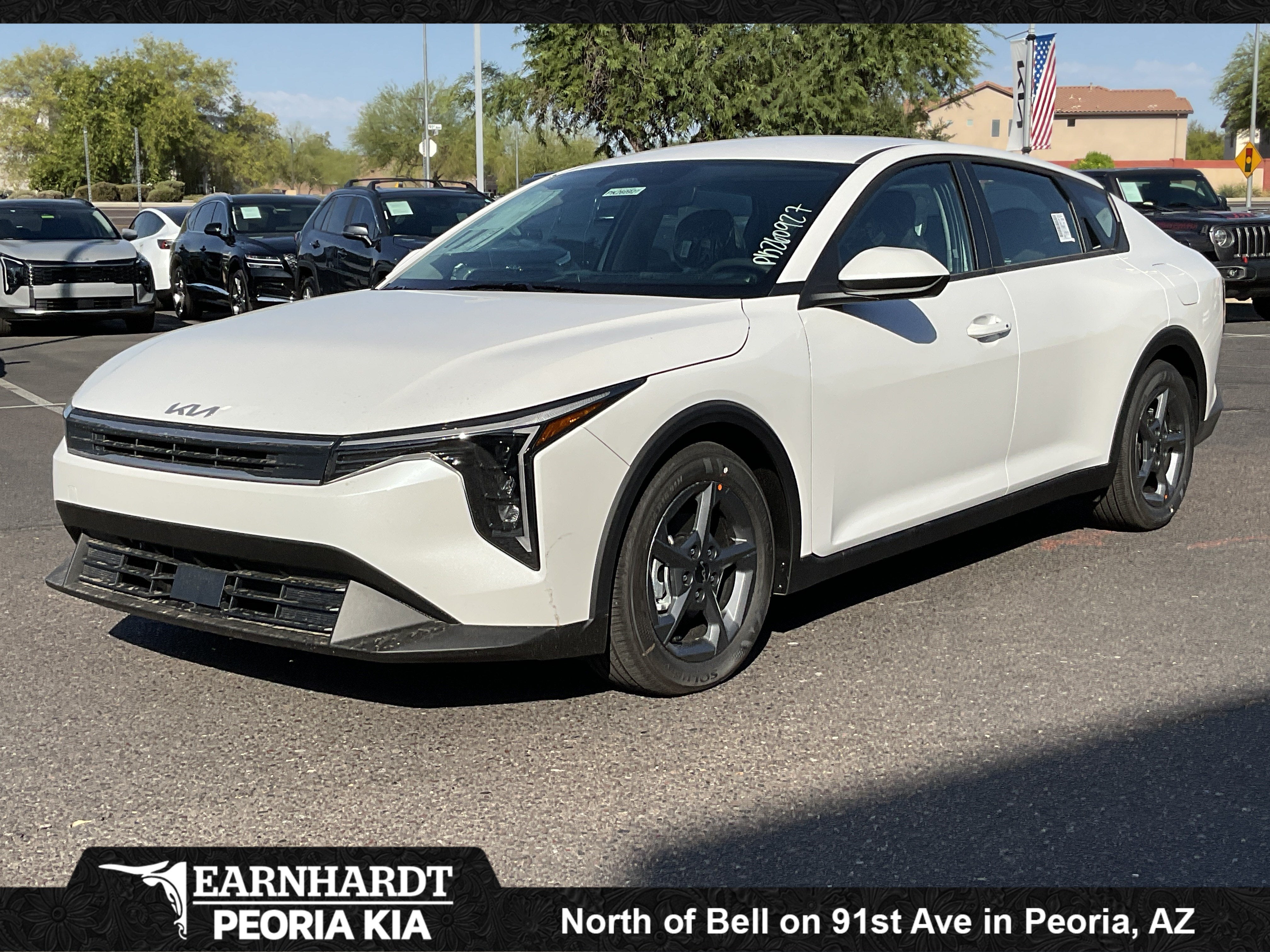 2026 Kia K4 LXS in Snow White Pearl — front three-quarter view