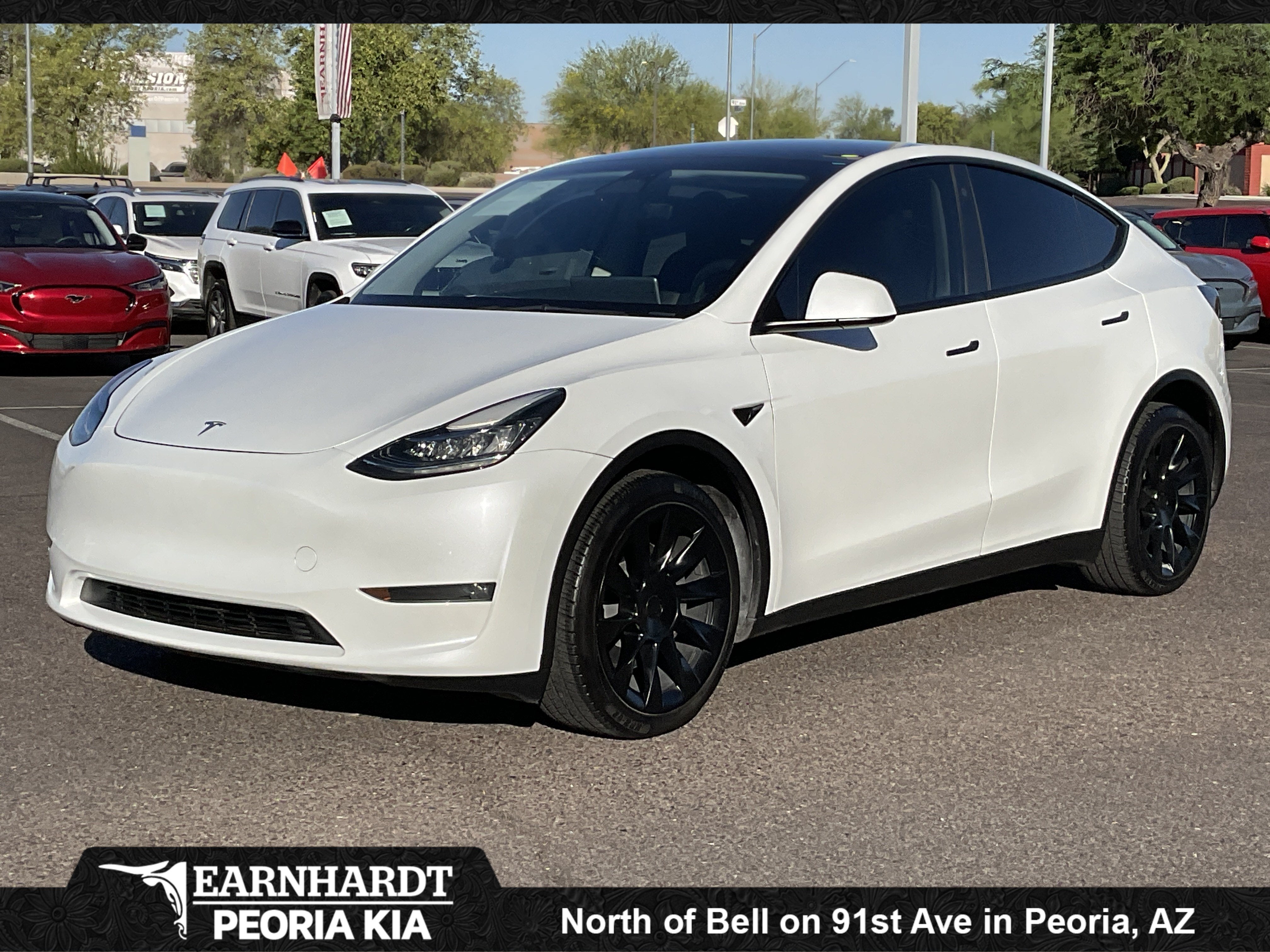 2023 Tesla Model Y Long Range in Pearl White Multi-Coat — front three-quarter view