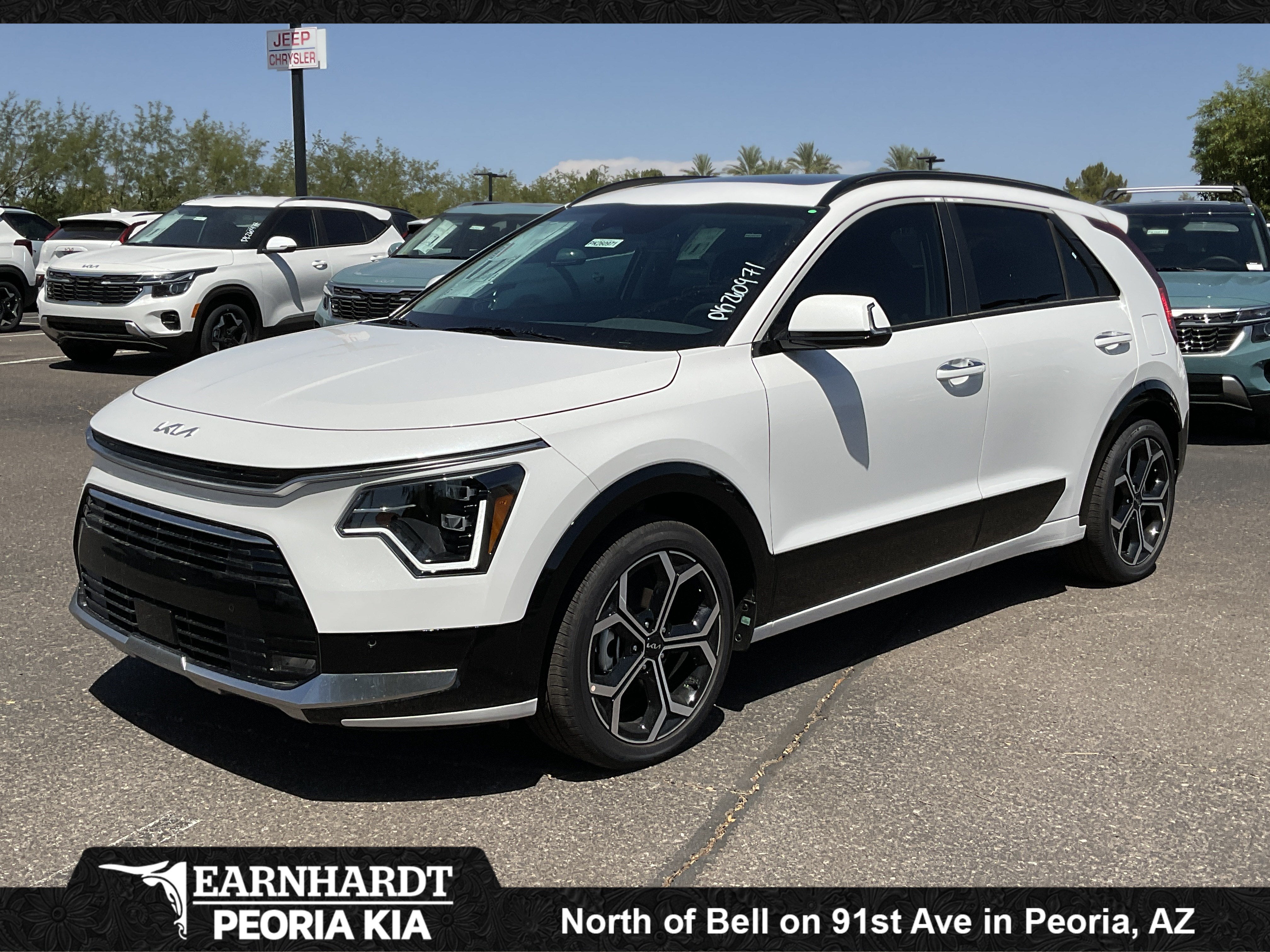 2026 Kia Niro SX Touring in Snow White Pearl — front three-quarter view