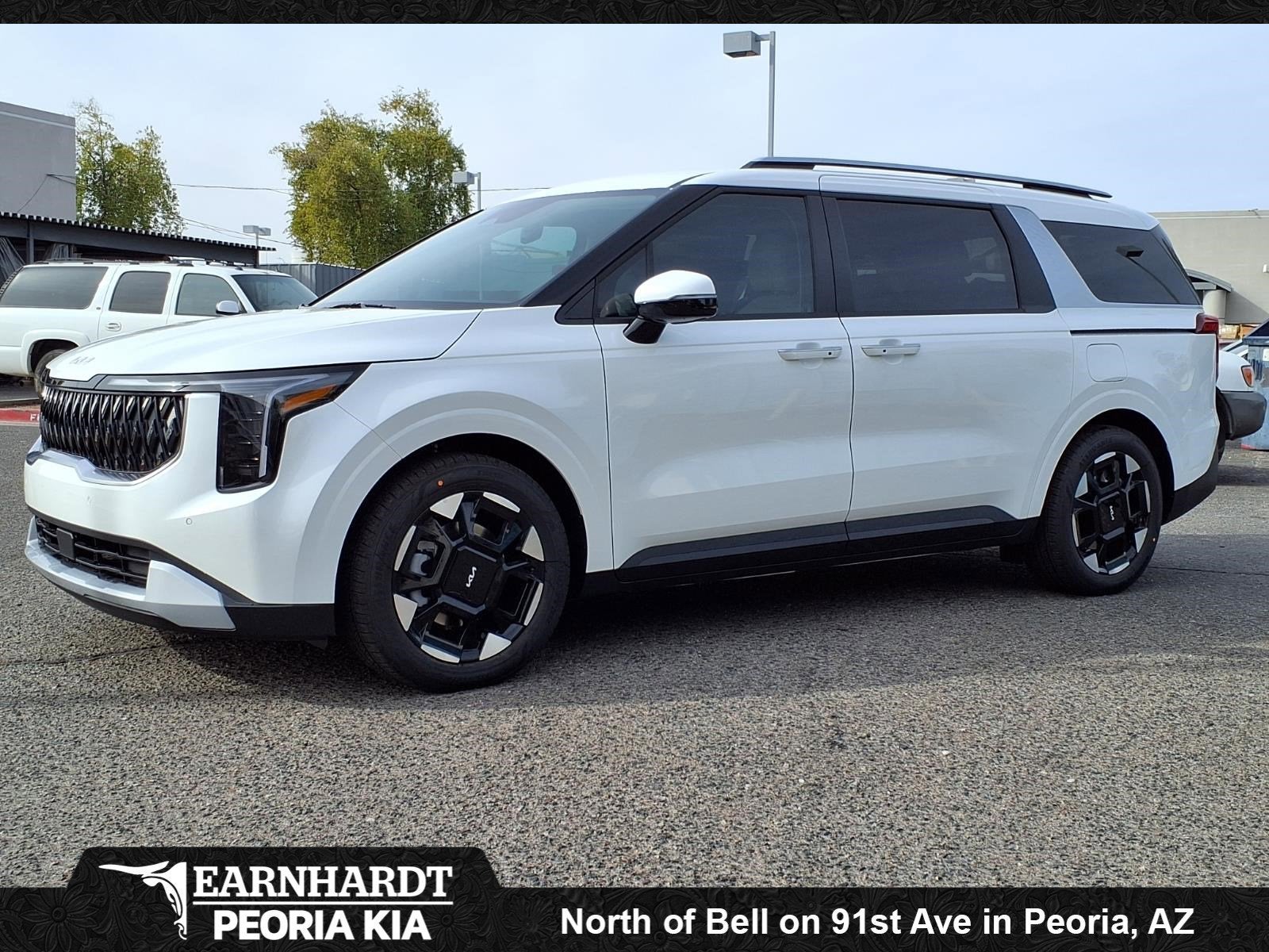 2026 Kia Carnival EX in Snow White Pearl — front three-quarter view