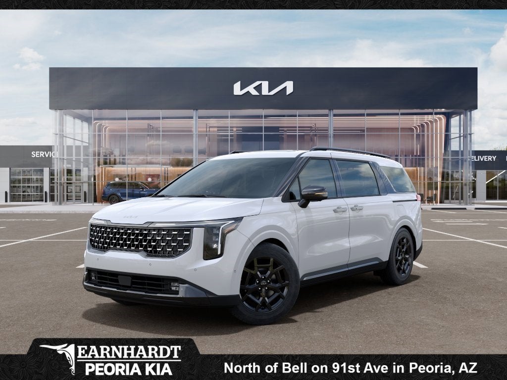 2026 Kia Carnival SX in Snow White Pearl — front three-quarter view